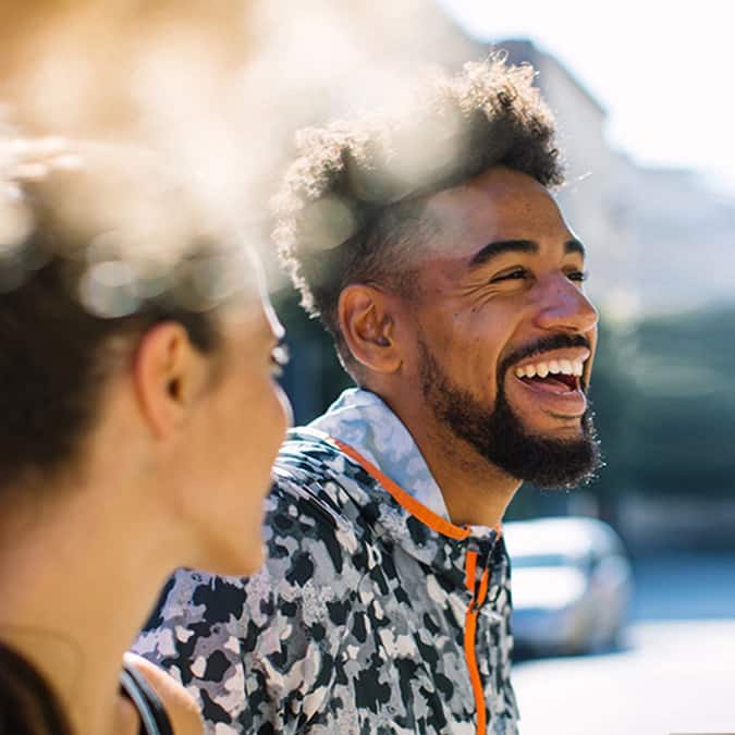 man smiling next to woman 