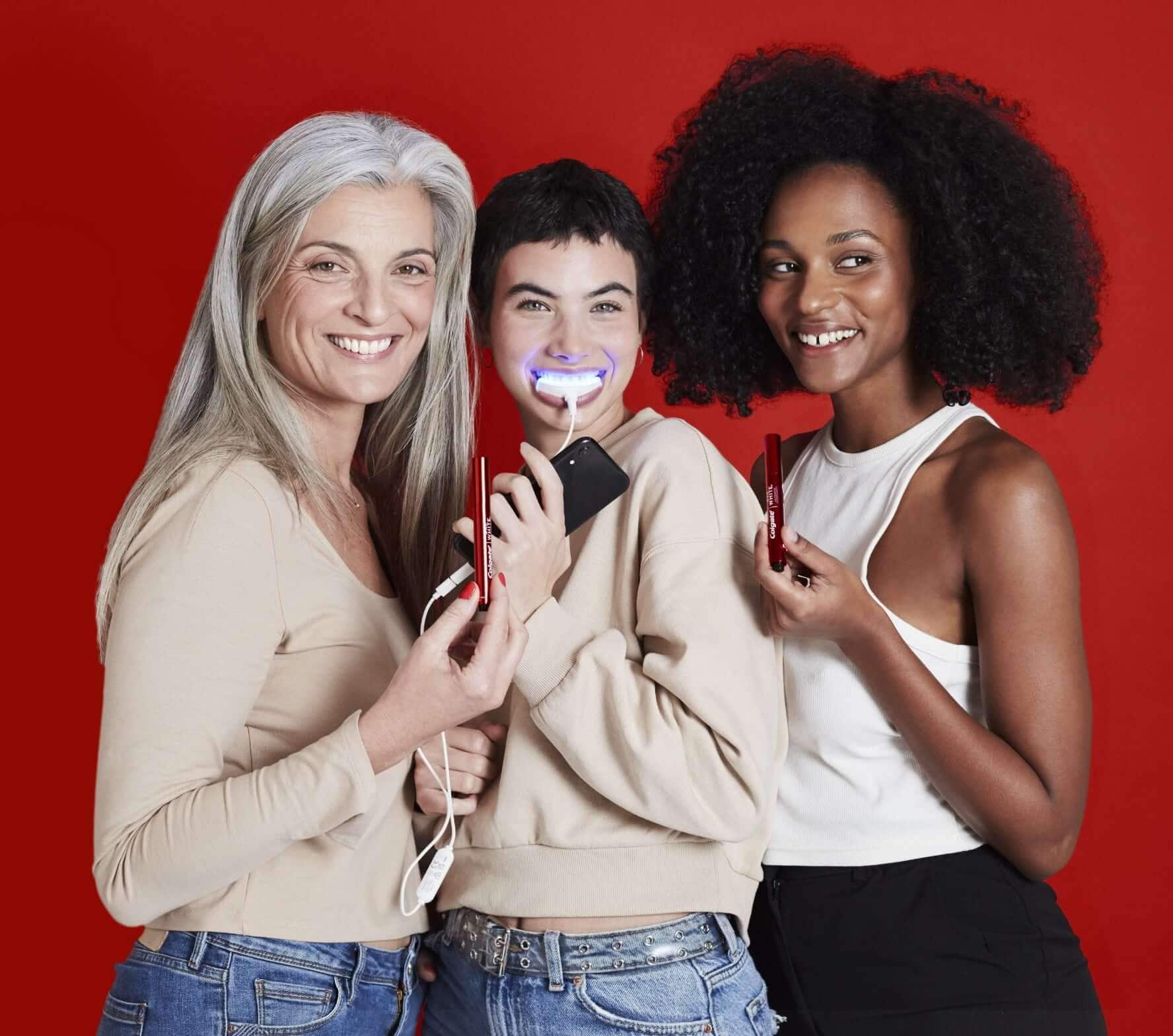 Three ladies using Max White whitening products